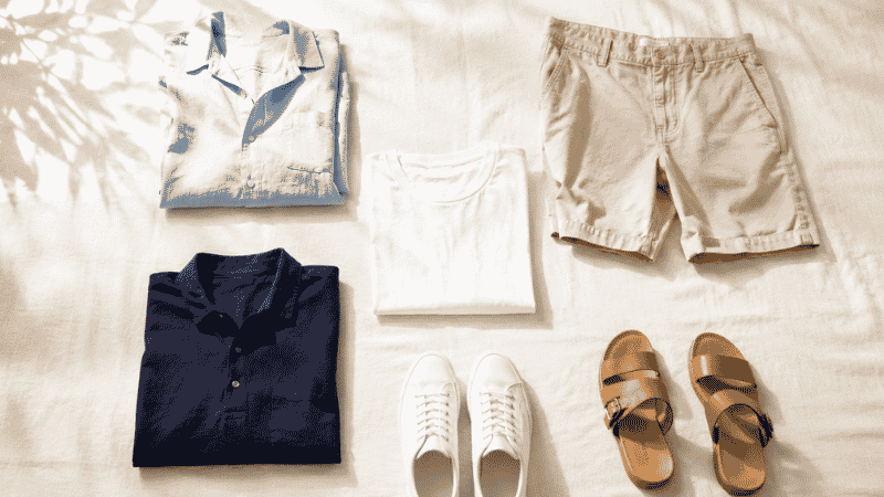 men's summer outfit ideas flat lay showing linen shirt chino shorts white t-shirt polo and leather sandals for hot weather