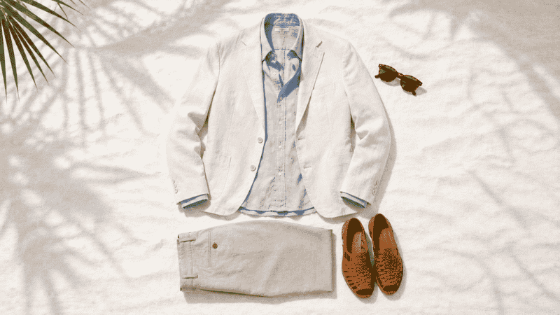 men's beach wedding outfit flat lay with ivory linen blazer light blue linen shirt tan chinos and leather sandals for outdoor destination wedding