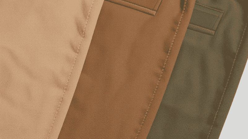 A flat-lay comparison of three distinct menswear khaki shades: light sand, classic British khaki, and dark olive-tone chinos, showing the different undertones for styling